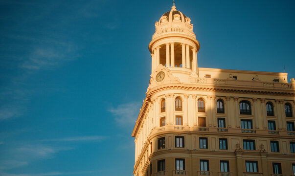 Golden hour light on historic building tower in Madrid Spain in cinematic style