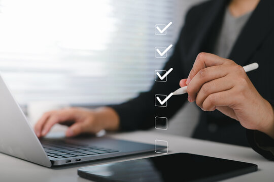 Businessman use pen to tick correct sign mark in checkbox for quality document control checklist and business approve project concept.
