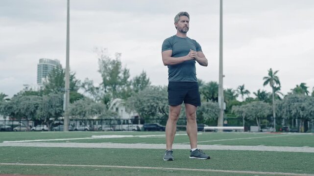 Mature athlete squat situp. Hispanic man training leg muscle doing squat exercise. Situp training. Man do squat exercise. Healthy lifestyle. Active man exercising outdoor