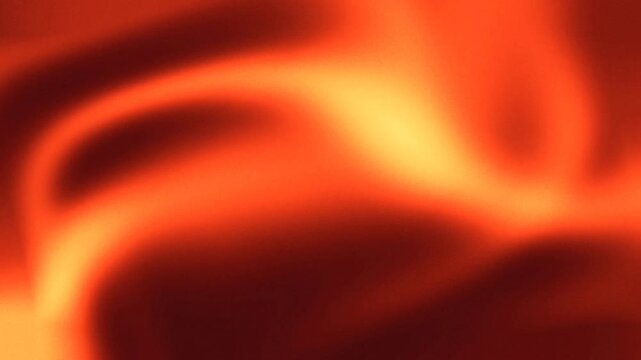 Seamless loop abstract motion background animation displaying warm orange and red fluid gradients with subtle grain and noise texture.