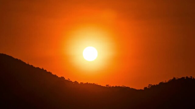 Peaceful sunrise time-lapse with warm golden light and fast-moving clouds.