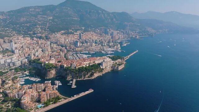 This footage features Monacos coastline, a vibrant city by the Mediterranean Sea. Spectacular views highlight the urban landscape and scenic harbor during daylight.