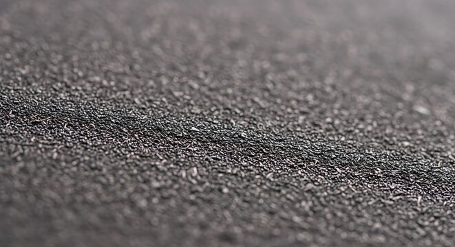 Close-up of black sand texture on a beach with abstract material volcanic