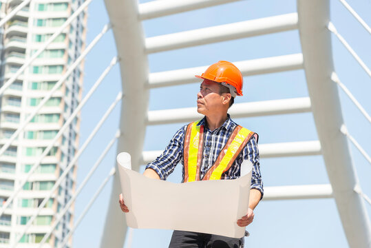 Engineer in uniform and helmet on of background the Construction Site power plant.