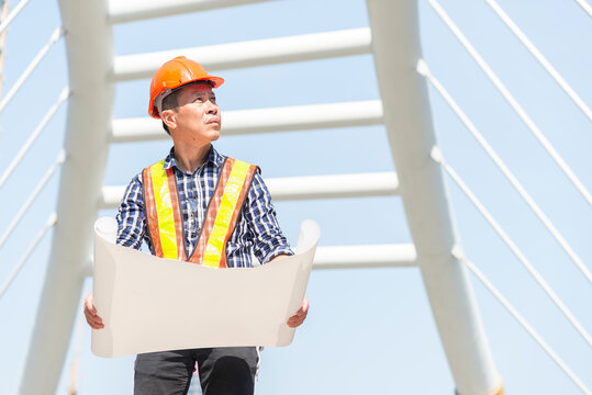 Engineer in uniform and helmet on of background the Construction Site power plant.