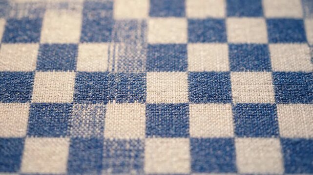 Blue and white checkered gingham fabric texture close up
