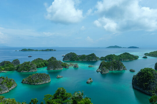 Aerial view of Piaynemo karst islands with liveaboard boats, Raja Ampat, Indonesia