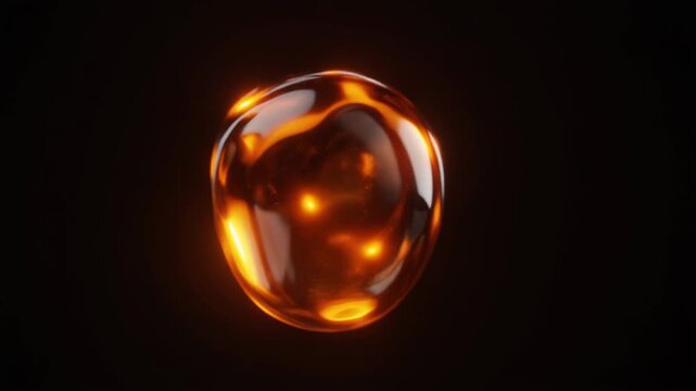 Glowing molten amber glass droplet in deep darkness
