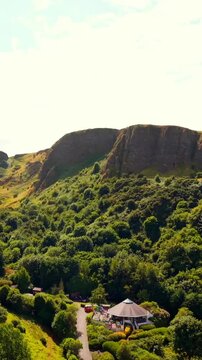 Clockwise 60FPS vertical social ratio aerial video of Cavehill in North Belfast, Northern Ireland in the UK on a bright sunny day. Produced with Rec709 colour.
