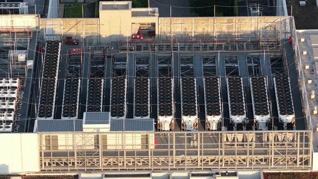Aerial view of large HVAC cooling equipment installed on a data center rooftop, showing industrial cooling infrastructure supporting servers, cloud computing and digital technology.