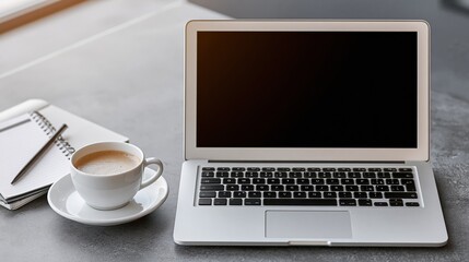 Fototapeta premium Modern Laptop with Coffee and Notebook on a Textured Desk Surface