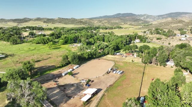Country road and residential acreage near West 1st Street captured from above, showcasing rural mountain living in Colorado.