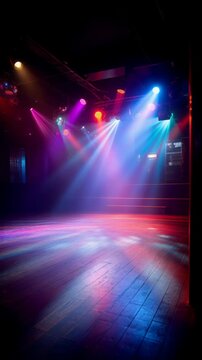 Colorful spotlights illuminating an empty wooden dance floor and stage in a dark nightclub