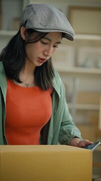 Women use laptop or phone for home office,package and e commerce checklist with stock to customer.Small business people with digital tech,logistics fulfillment,box and phone for online website order