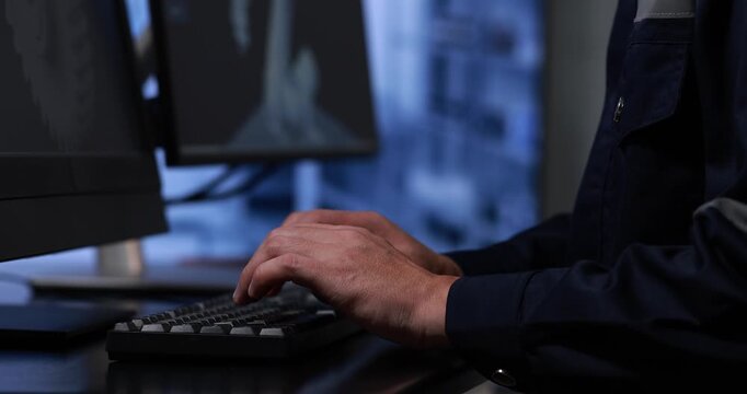 Close-up of a hand tapping a tablet screen on a desk in a modern workspace