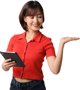 Happy asian woman holding digital tablet and presenting empty space with open palm on isolated transparency background