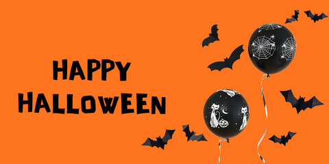 Fototapeta premium Halloween. Colorful black balloons and bats decorate festive Halloween backdrop