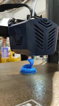 Process printing on 3D printer. The 3D printing process from molten plastic blue color. 3D printing technology. FDM technologies. Fused Deposition Modeling. Additive manufacturing. Vertical