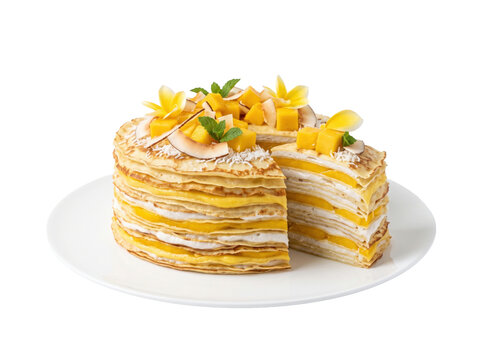 Tropical mango crepe cake on white background. Delicious layered fruit dessert isolated.