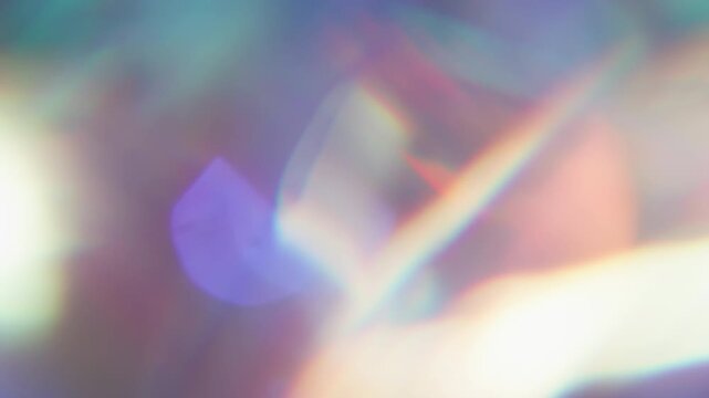 Defocused flare effect. Crystal prism. Colorful light rotation abstract background. Neon spectrum luminosity purple orange twinkle flash.