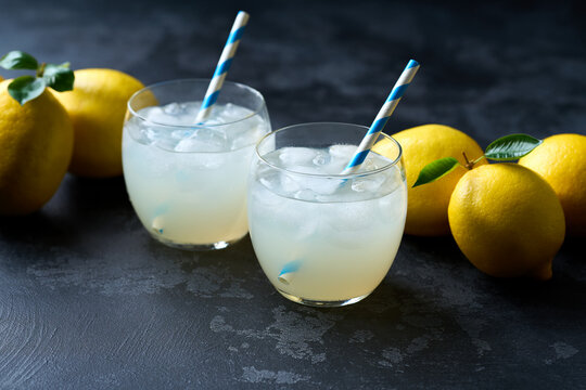 Refreshing homemade summer lemonade. Homemade lemonade  on a dark table. Freshly made lemonade with ice on dark table.