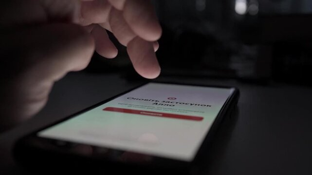 Close Up of Man Scrolling Social Media on Smartphone in Dark Room at Night