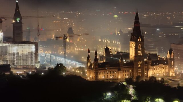 Ottawa skyline at night with Parliament Hill, city lights, haze, smog and pollution above the Ottawa River. g.