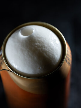 Close-up of draft beer foam on a can