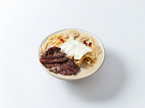 Cream sauce pasta with meat on a plate
