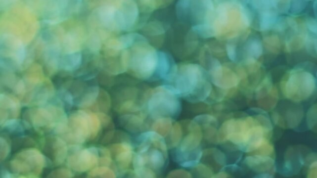 Defocused circles. Blur sparkle. Color shimmering mystic light effect. Shine flare leak transition texture abstract blue yellow background.