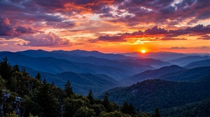 Fototapeta premium Mountain ridges glowing at sunset over layered valleys