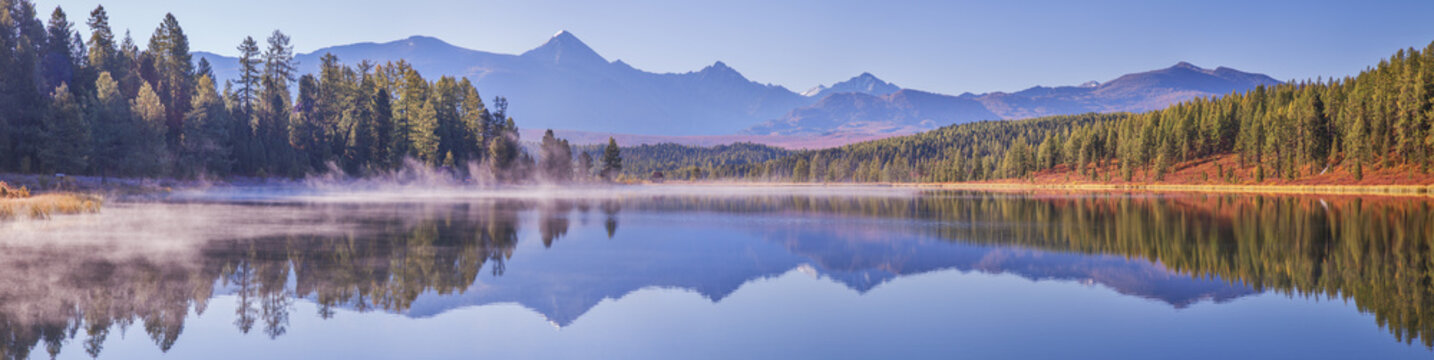 Mountain lake on an autumn morning, forest shores, picturesque reflection in the water