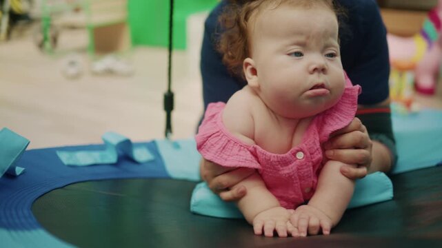 Physiotherapist assisting baby with Down Syndrome during developmental therapy, supporting early childhood development and special needs