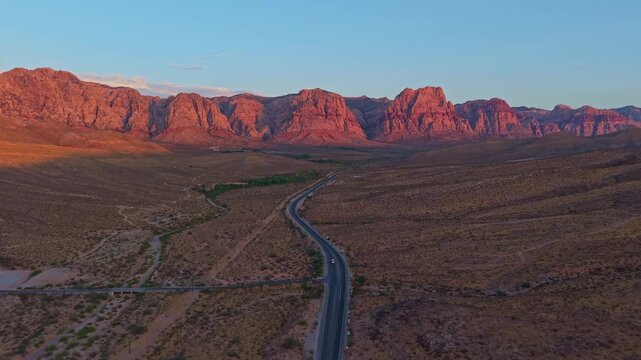 Aerial view of glowing sandstone mountains at sunrise in Red Rock Canyon Nevada
