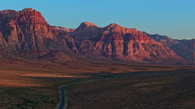 Aerial view of glowing sandstone mountains at sunrise in Red Rock Canyon Nevada