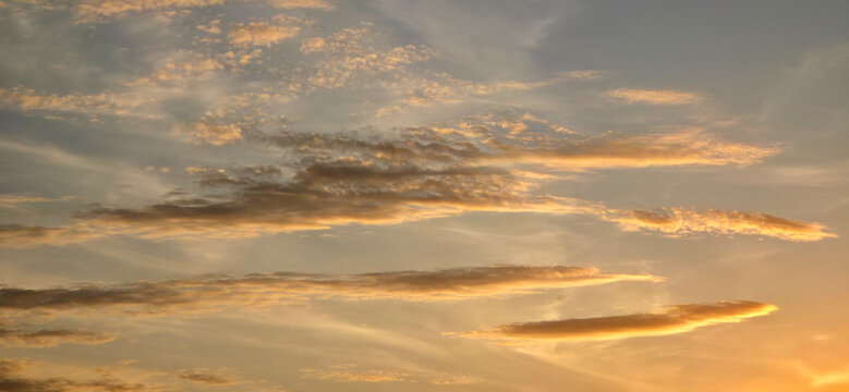 Dramatic Sunset Sky with Golden Clouds Background