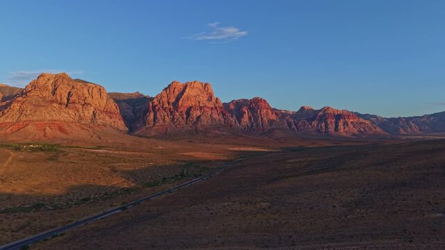 Aerial view of glowing sandstone mountains at sunrise in Red Rock Canyon Nevada