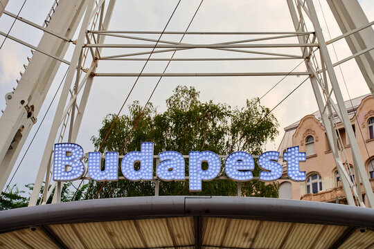 Illuminated Budapest sign on ferris wheel structure
