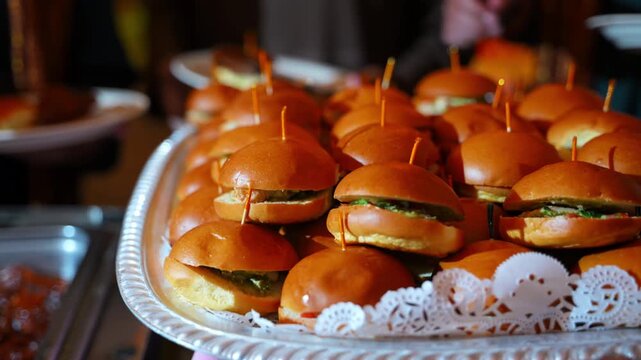 Close up of plates with meat free sandwiches at a self-service food station during a banquet, corporate event, or private celebration.
