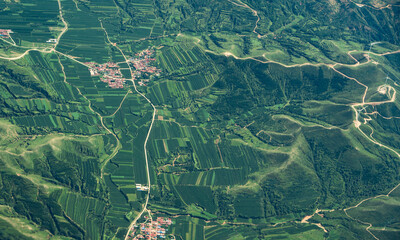 Naklejka premium aerial view of green agriculture field in mountain area