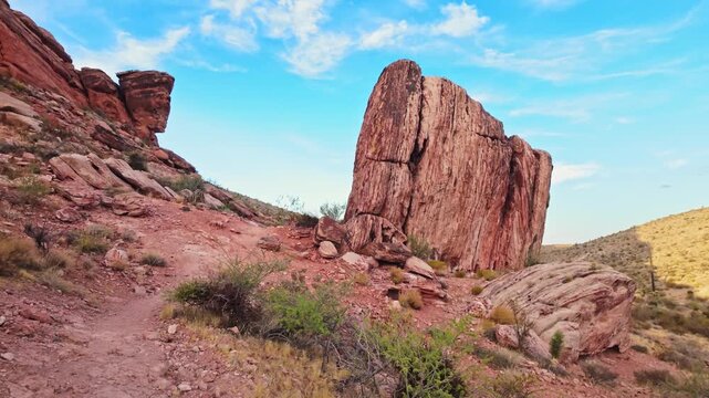 Massive red sandstone rock formation rising in the desert terrain of Calico Basin near Red Rock Canyon Nevada