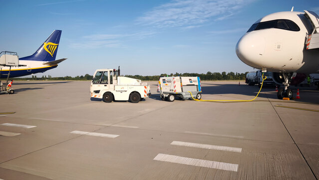 August 2026. Germany. Karlsruhe Baden-Baden Airport. Ground power unit connected to a commercial airplane on an airport tarmac. Aviation ground handling operations
