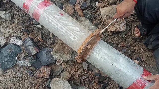 INDUSTRIAL PIPE MAINTENANCE AND METAL CLAMP ADJUSTMENT ON CONSTRUCTION SITE