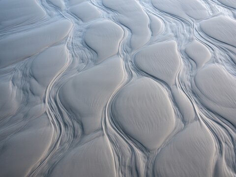Overhead composition of flowing sand creating beautiful ephemeral patterns v2-6x