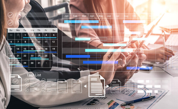 A diverse team collaborates on project planning using digital tools, showcasing calendars, task lists, and charts in a modern office for enhanced productivity and organization. Gantry