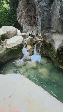 Brewing Tea Over a Campfire in a Hidden Rocky Canyon with Cascading Waterfalls