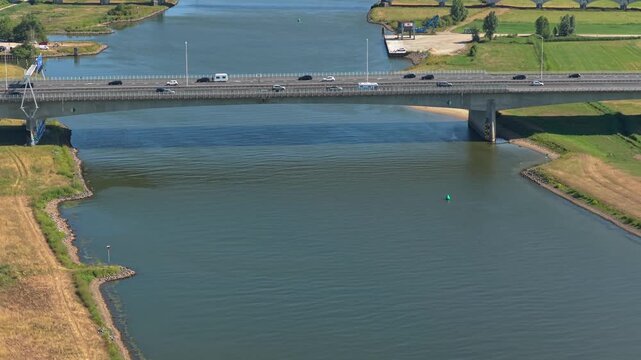 Aerial footage revealing multiple bridges, including a highway and railway, spanning the ijssel river near zwolle in the netherlands