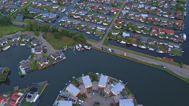 Unique aerial perspective flying over the picturesque water village of lemmer, netherlands, revealing its intricate canals and modern architecture