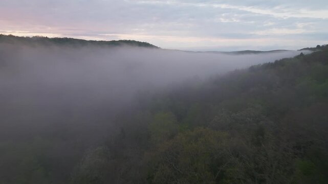 Flying through low clouds at sunset in Washington, Connecticut during summer.