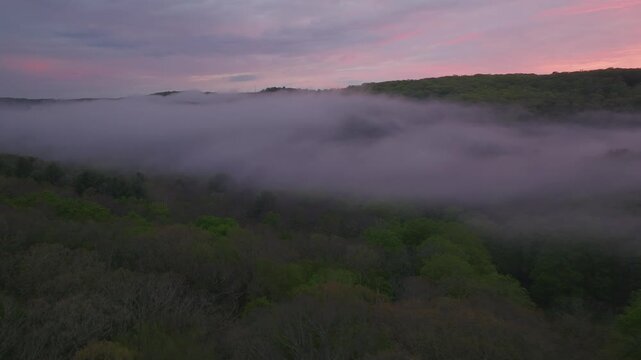 Flying through low clouds at sunset in Washington, Connecticut during summer.